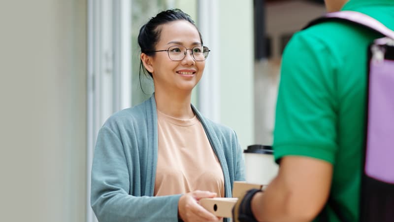 Photograph of a person receiving a food delivery order