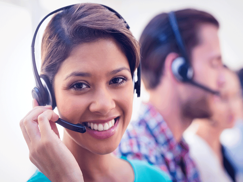 Smiling female customer service agent wearing headset