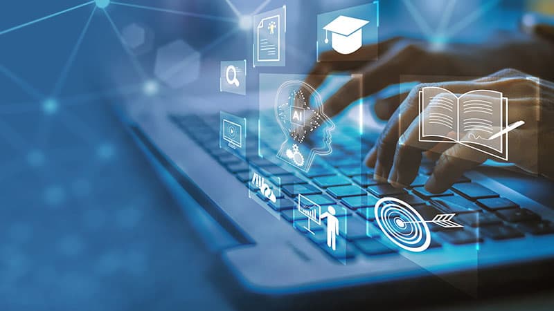 Hands typing at a keyboard with superimposed images of a graduation cap, notebook, bullseye and more.