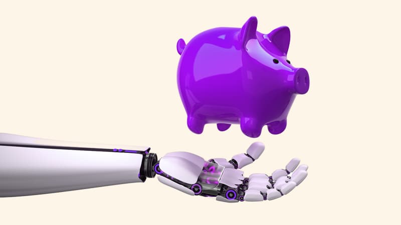 A piggy bank falling into a robot hand