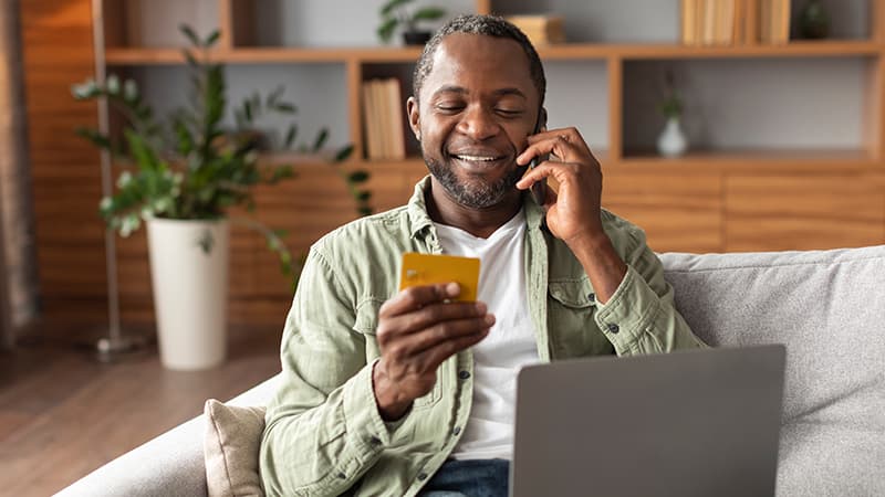 Happy financial services customer speaking to an agent over the phone.