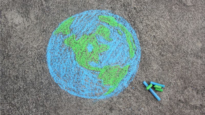 image of world drawn on pavement with chalk