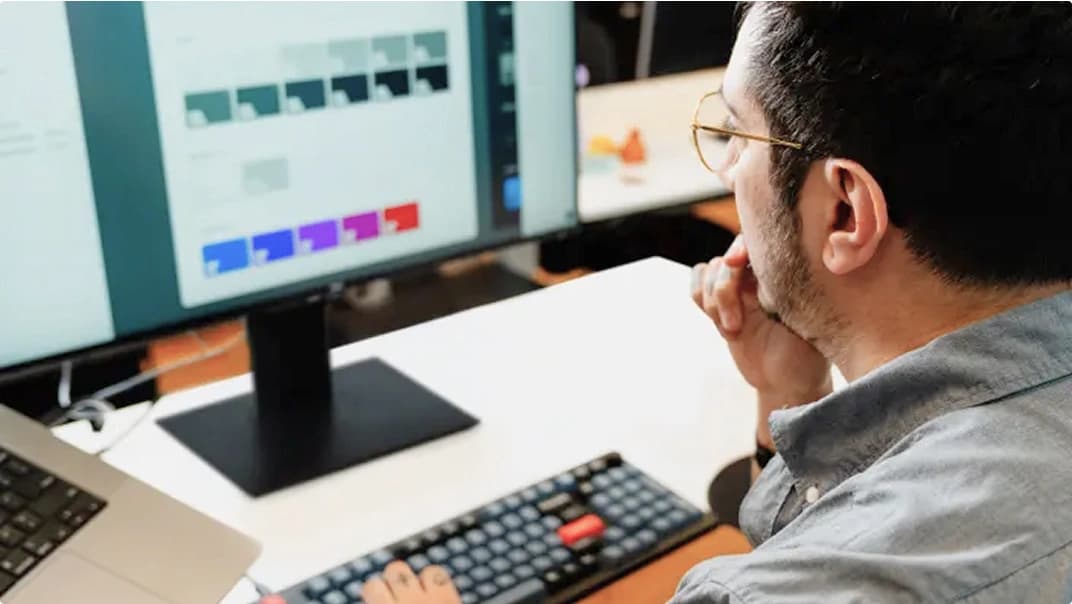 A man working on colour schemes on their computer