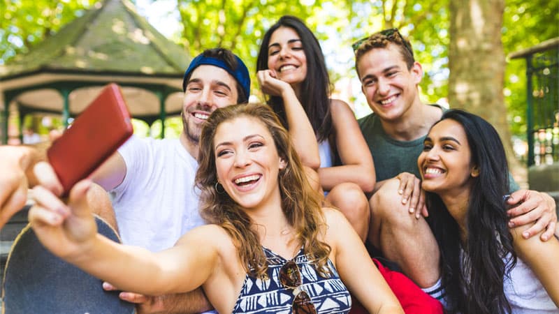 Group of Millenials taking a selfie in the park