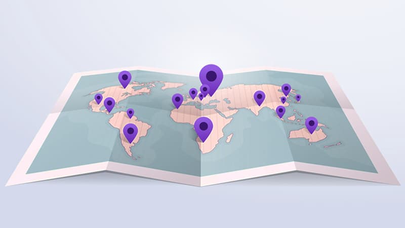 Illustration of a paper map of the world with pins in various locations