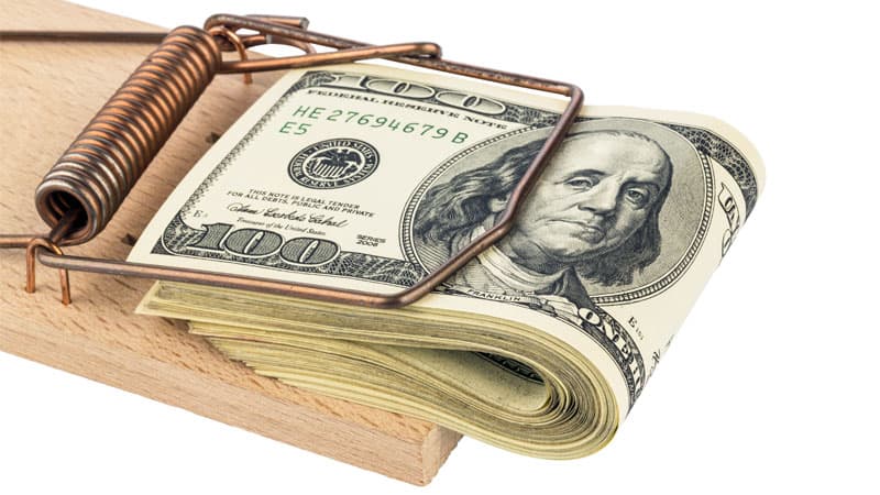 one hundred dollar bills in a mouse trap