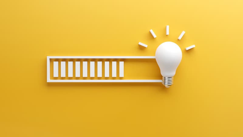 Lightbulb at the right end of a loading bar over a yellow background